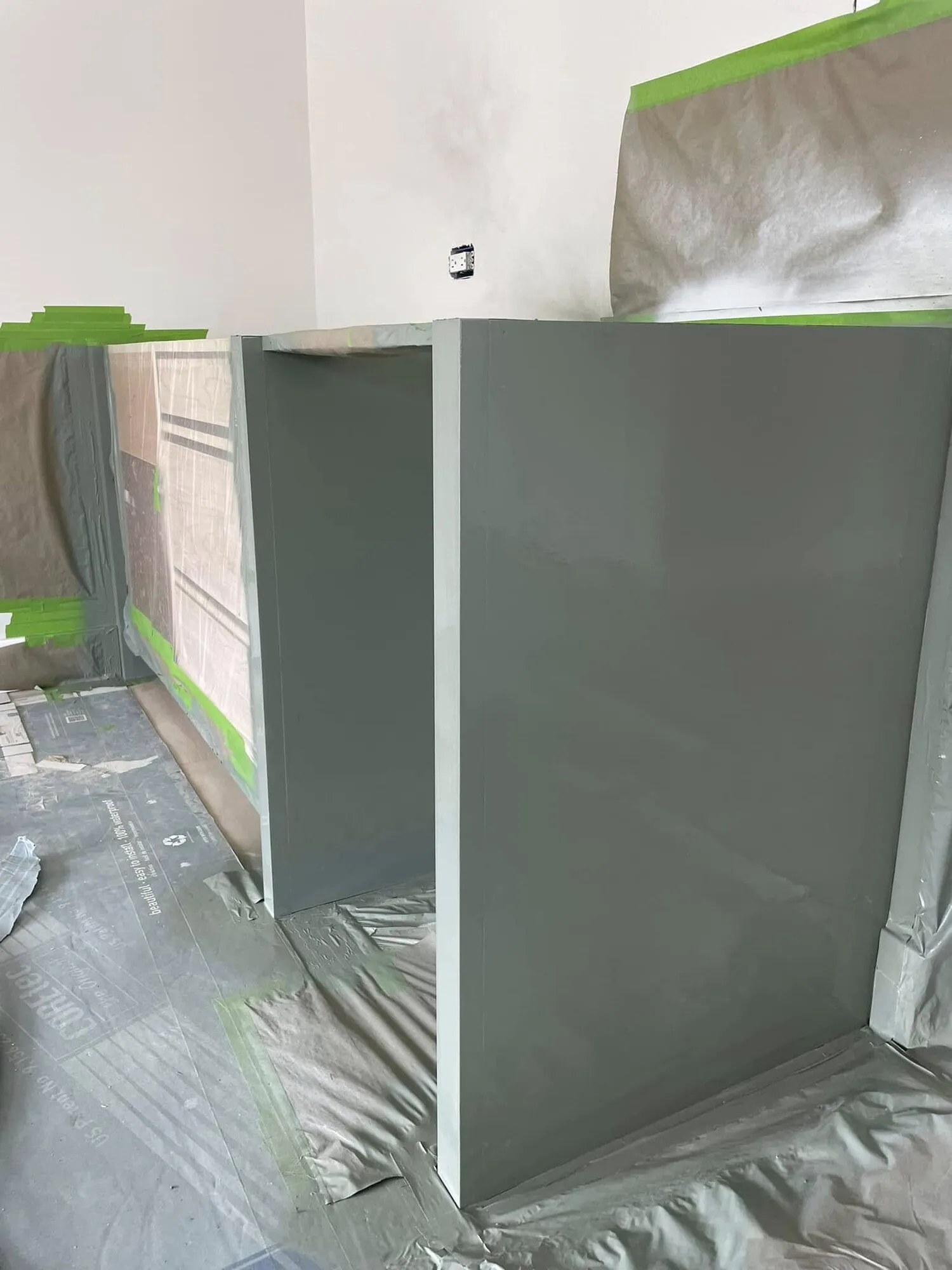 Built-in cabinet painted a muted sage gray-green
