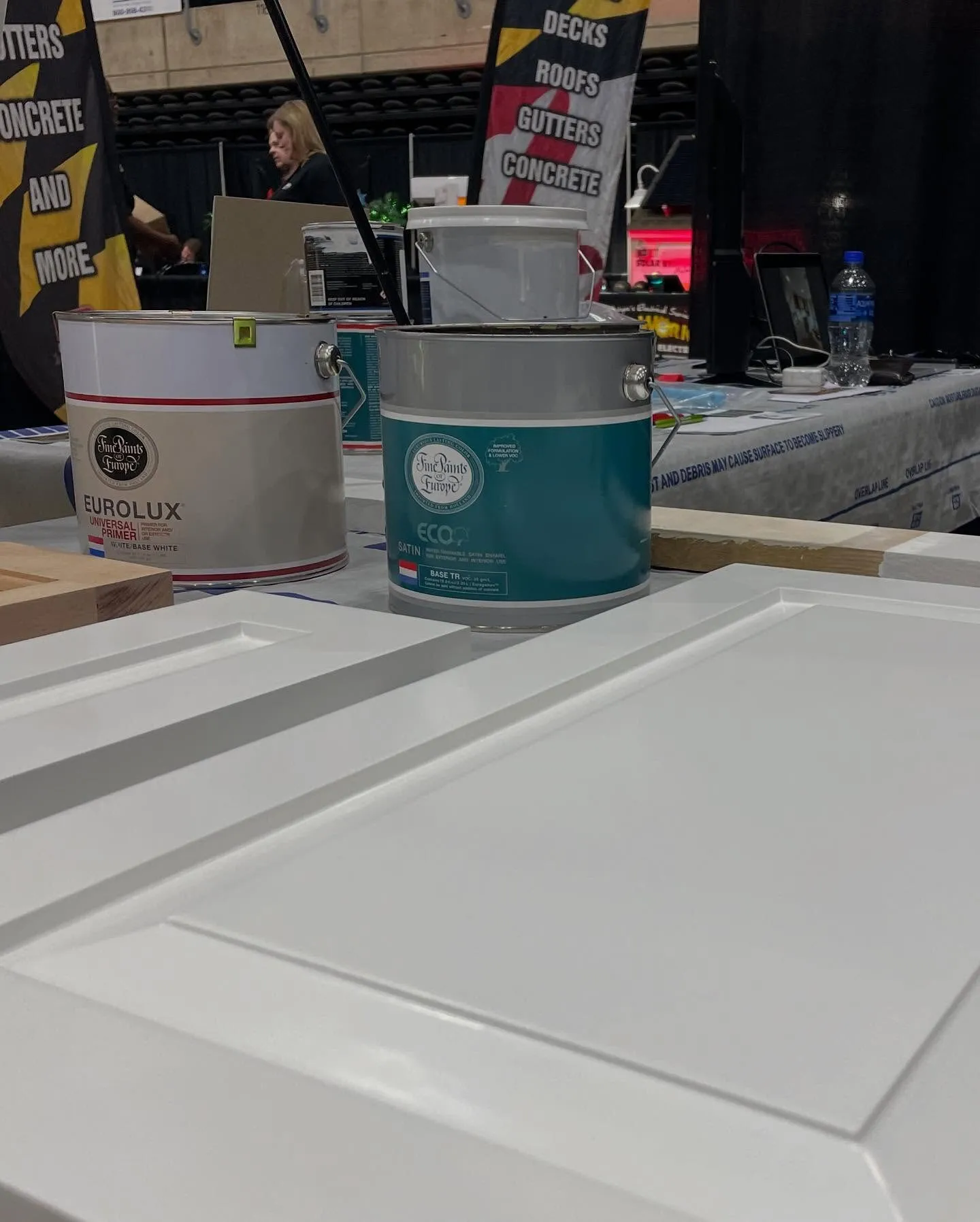 Fine Paints of Europe paint cans on a freshly coated white cabinet door