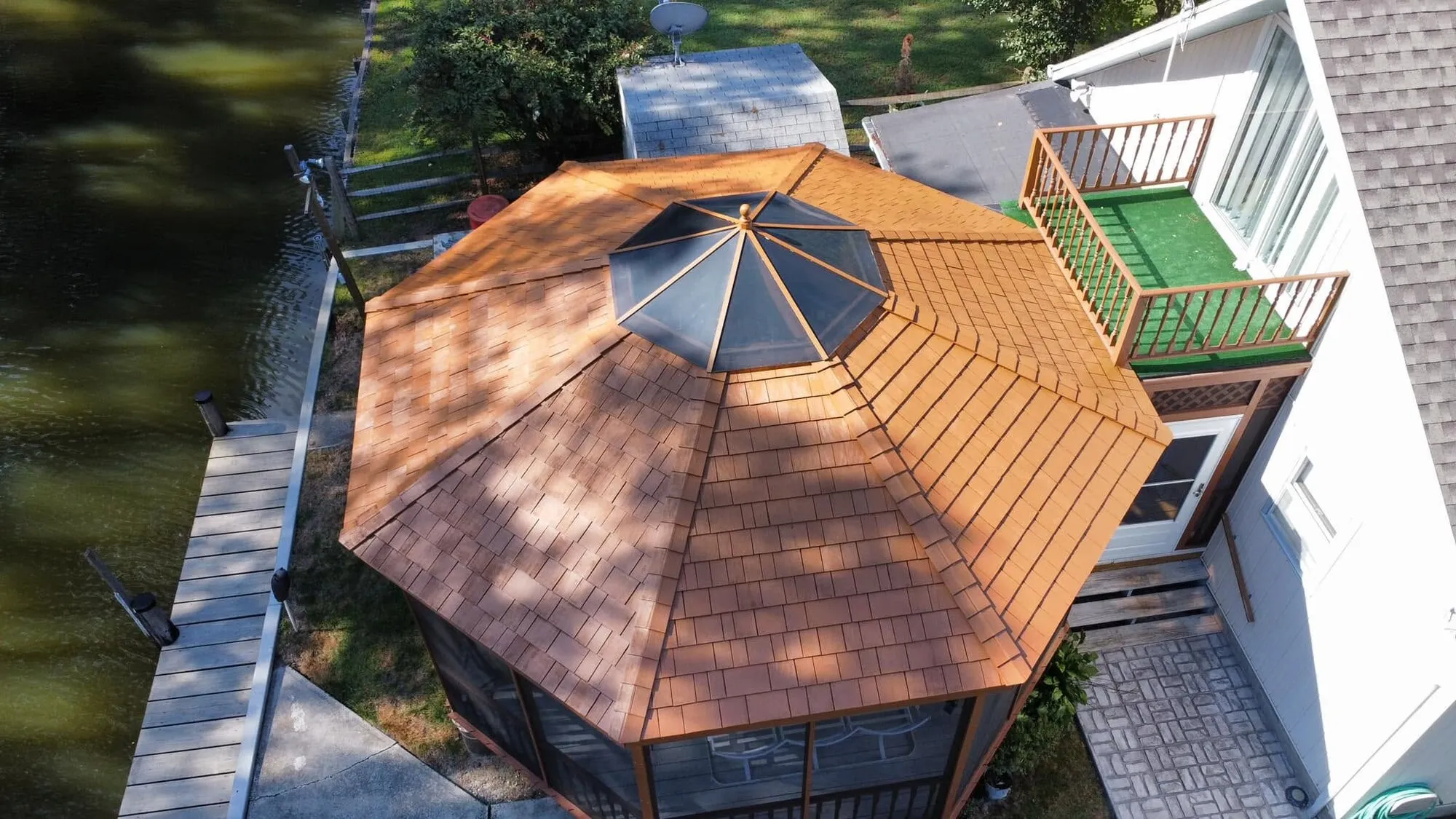 After: the same waterfront gazebo roof restained a rich cedar tone