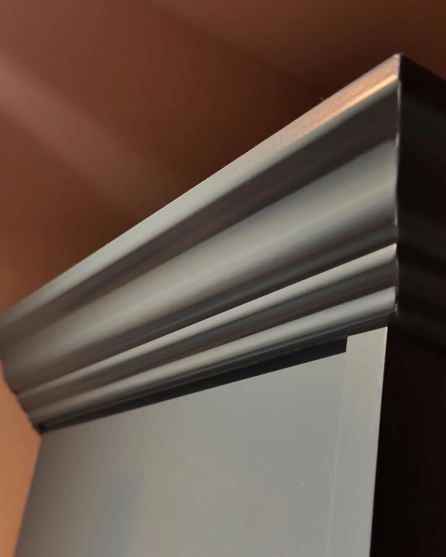 Close-up of a crown moulding profile with a flawless painted finish