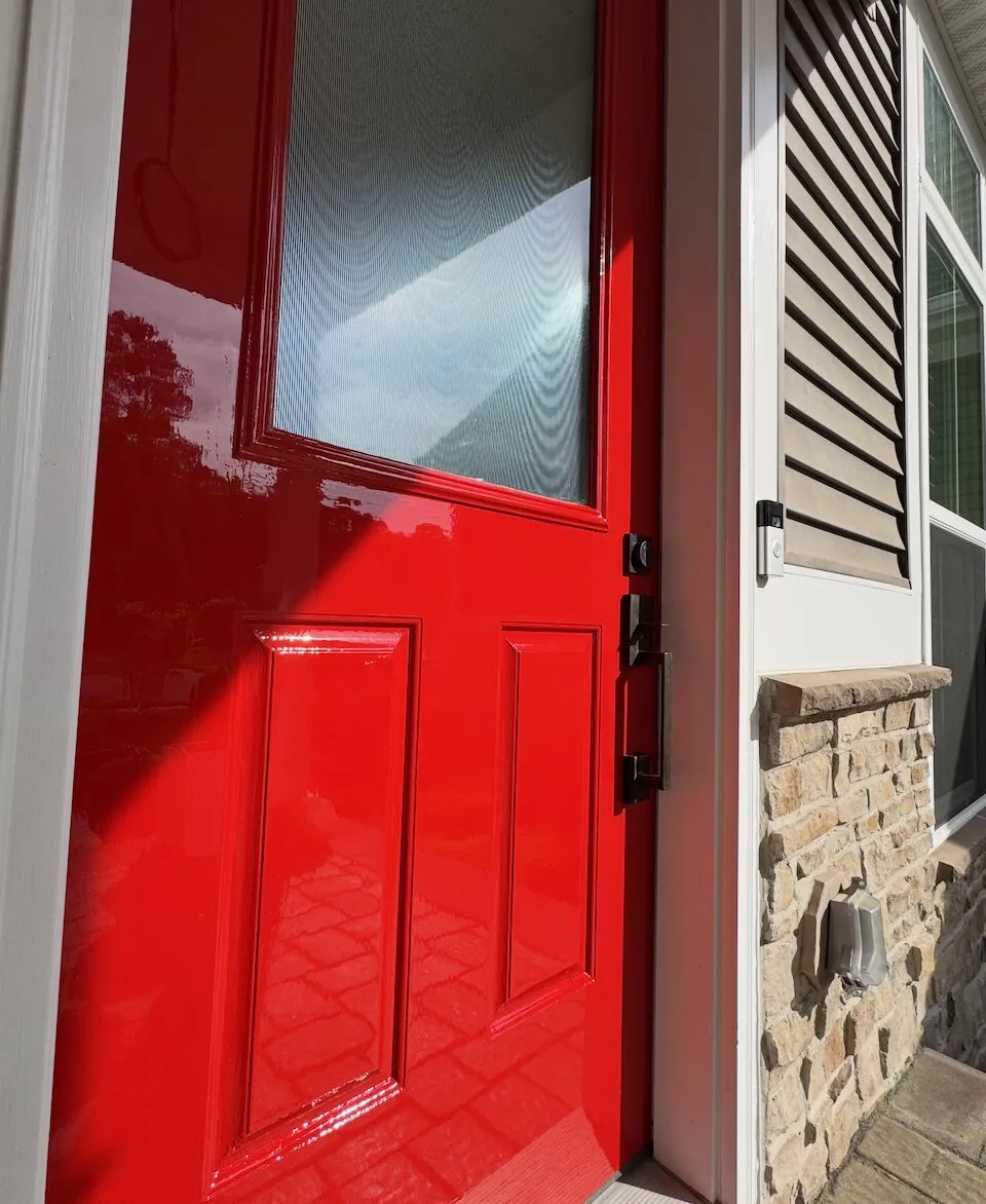Red front door with a mirror-like high-gloss finish