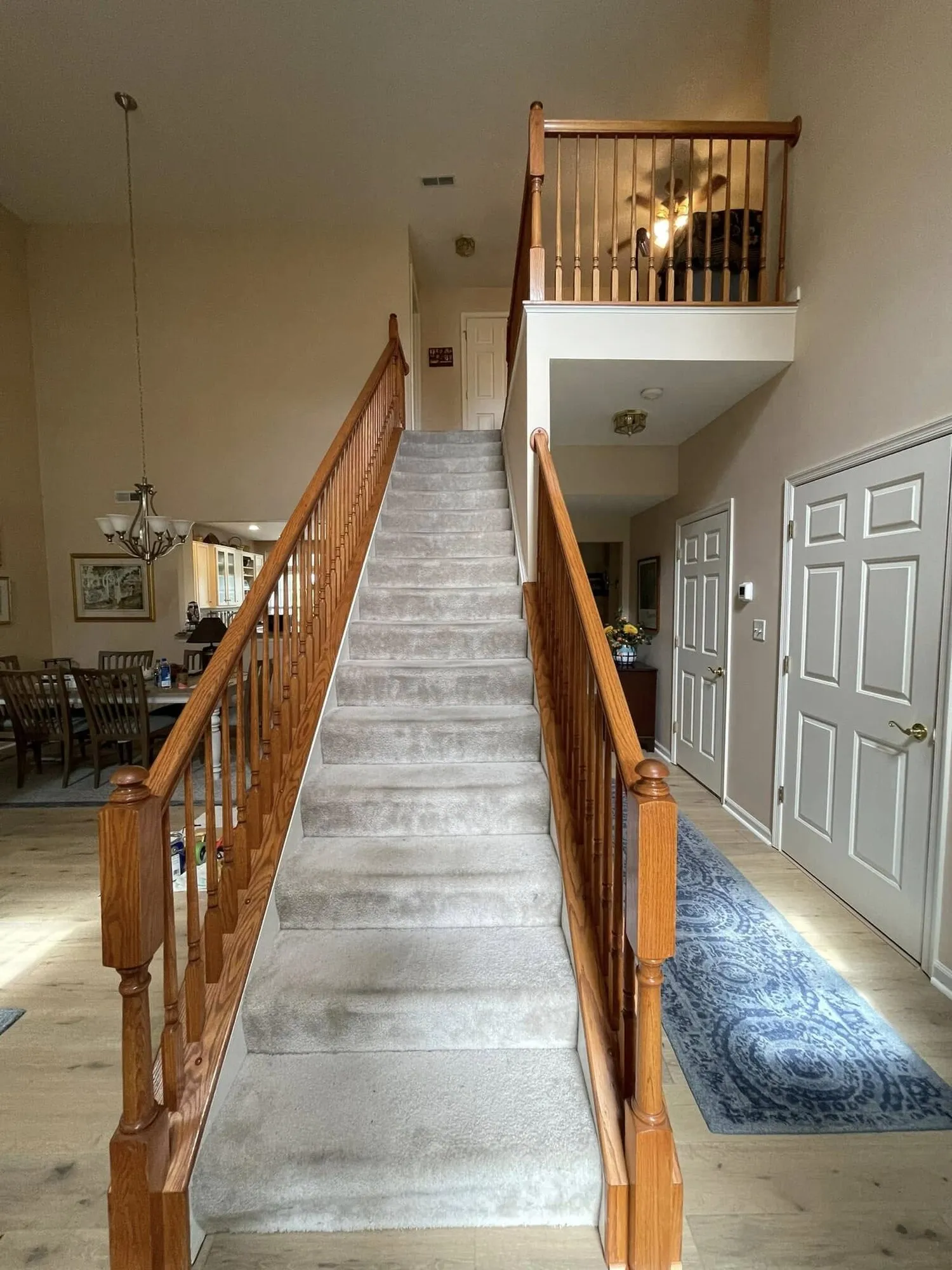 Before: staircase with dated orange oak railings and balusters